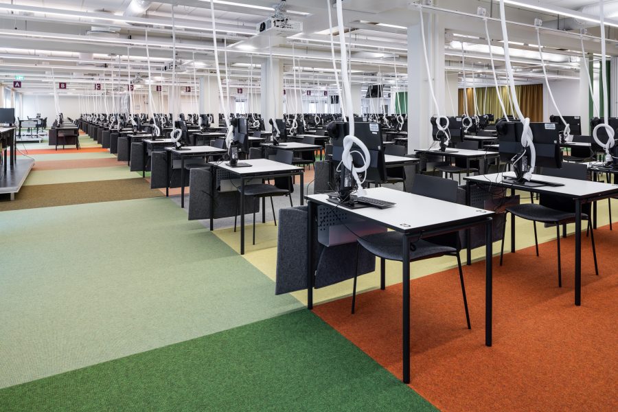 Heltäckande matta Tretford lagd i olika färgfält under skrivbord i Karolinska Skrivsal, Link Arkitektur.